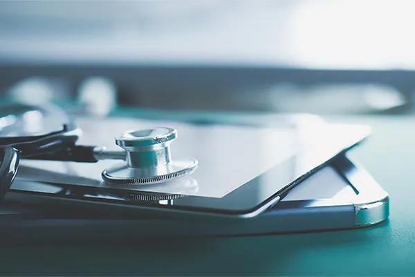 Advanced-Diagnostic-Testing-Clinic Close up of a stethoscope lying on a tablet, representing advanced functional medicine testing offered by Kane Lai, MD in Dallas-Fort Worth Metroplex.
