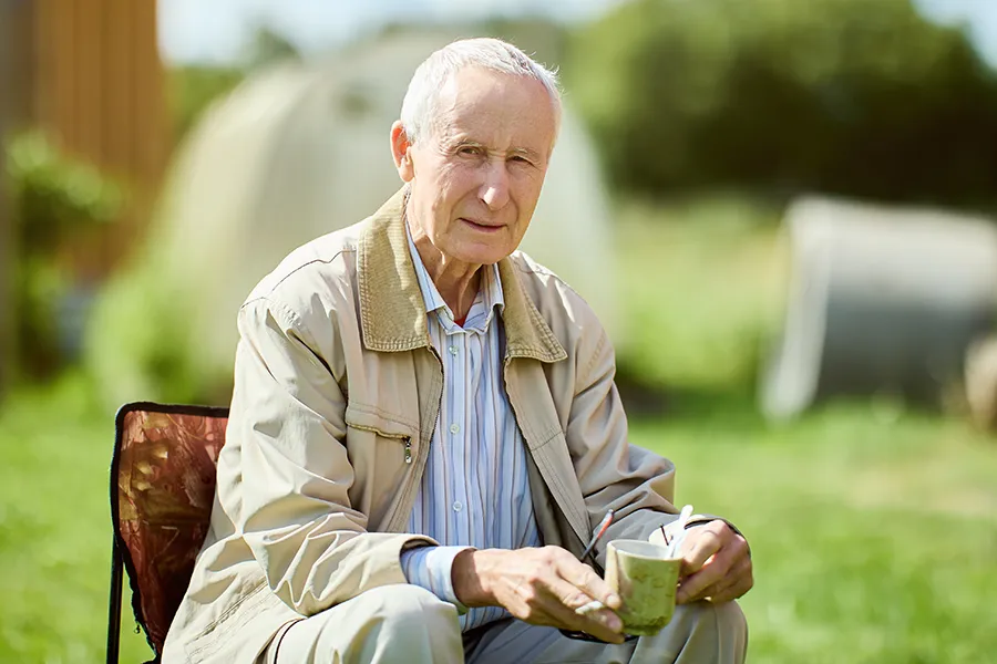 Muscle-Atrophy-Clinic A very thin older man sits outside. Get treatment for muscle atrophy from Kane Lai, MD in Dallas-Fort Worth Metroplex.