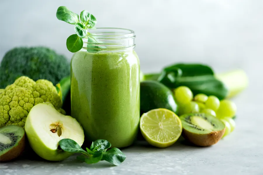 Nutritional-Counseling-Clinic A tableau of healthy green fruits and vegetables and juices. Get nutritional counseling from Kane Lai, MD in Dallas-Fort Worth Metroplex.